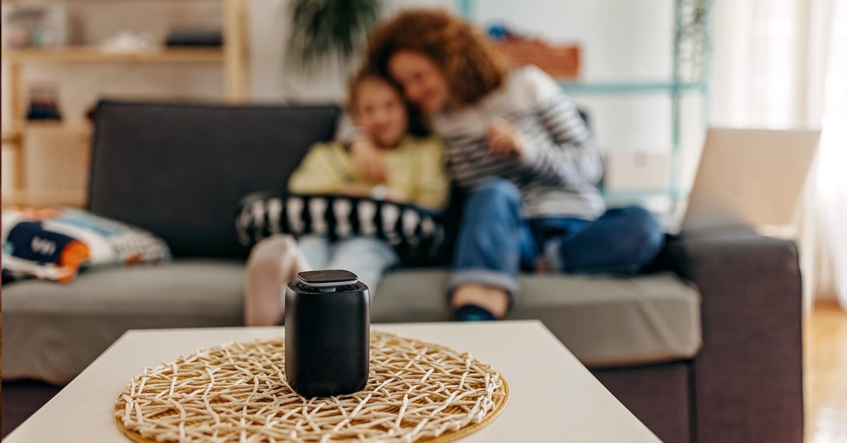smart speaker sitting on a table in a family's living room