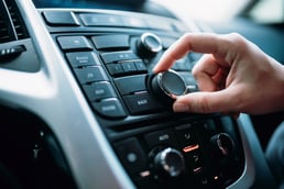 Person tuning the car radio
